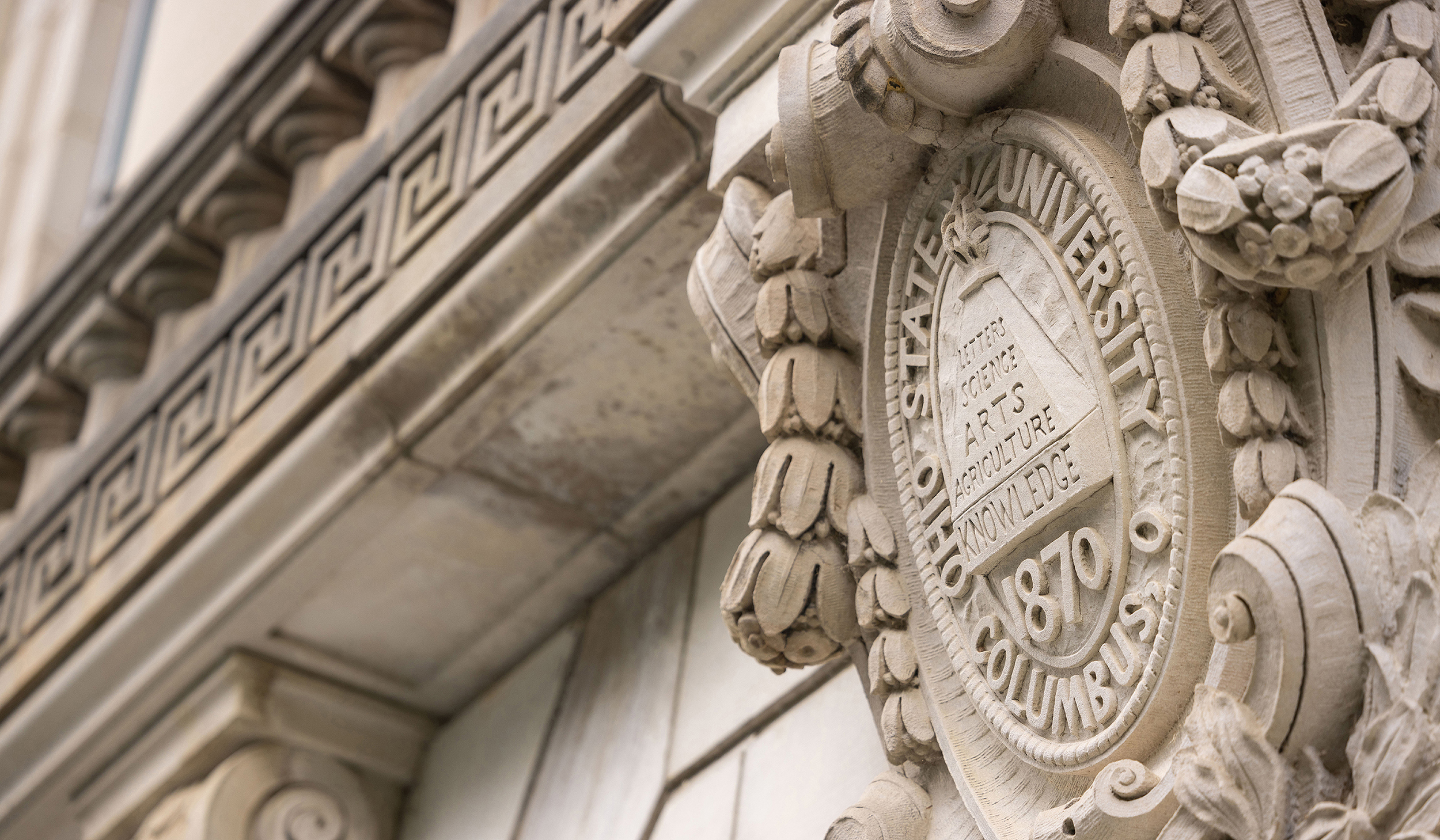 Architectural detail of the Ohio State University seal etched into the limestone on the east facade of the library.