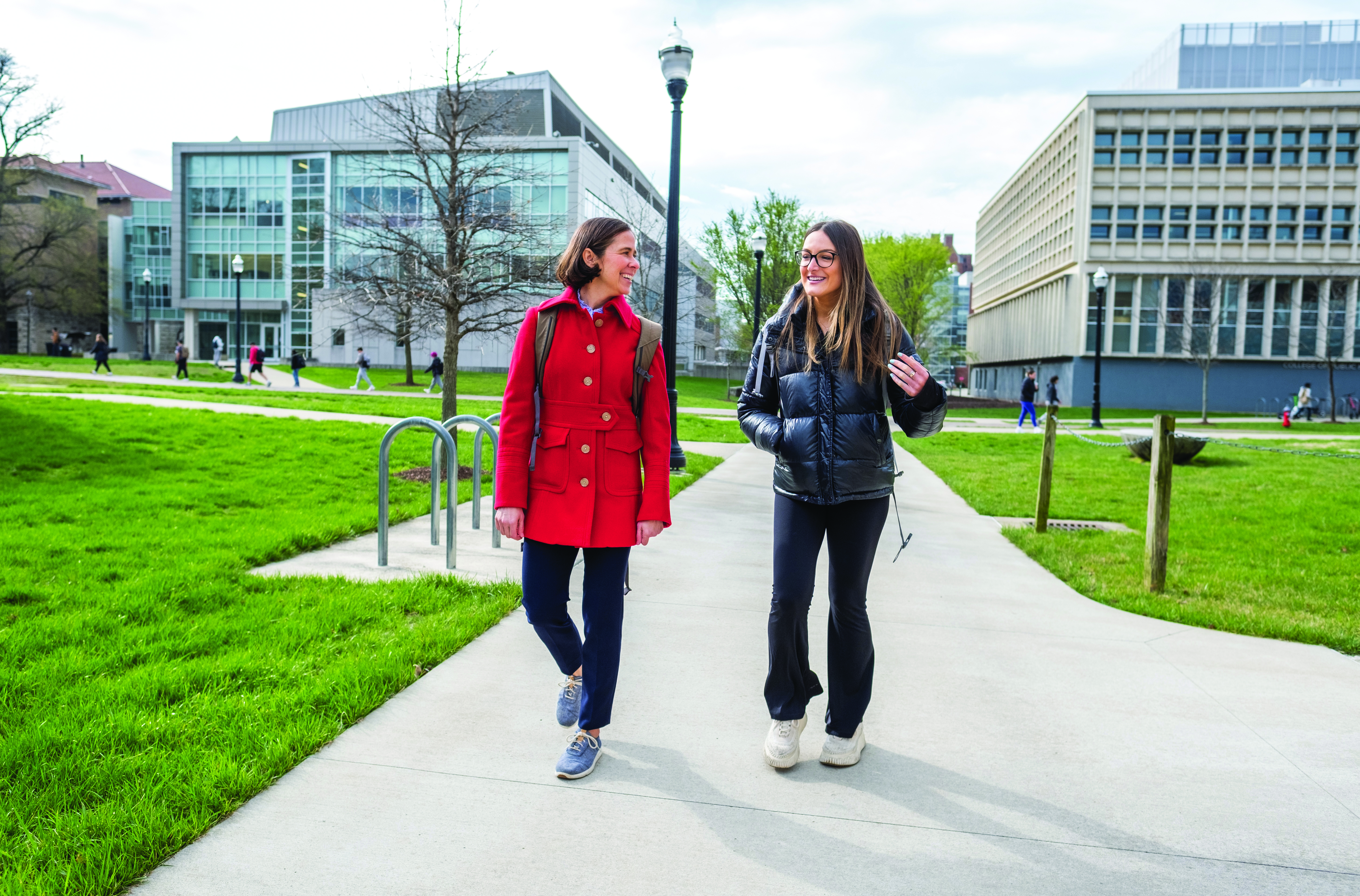 Faculty member and student walking on campus