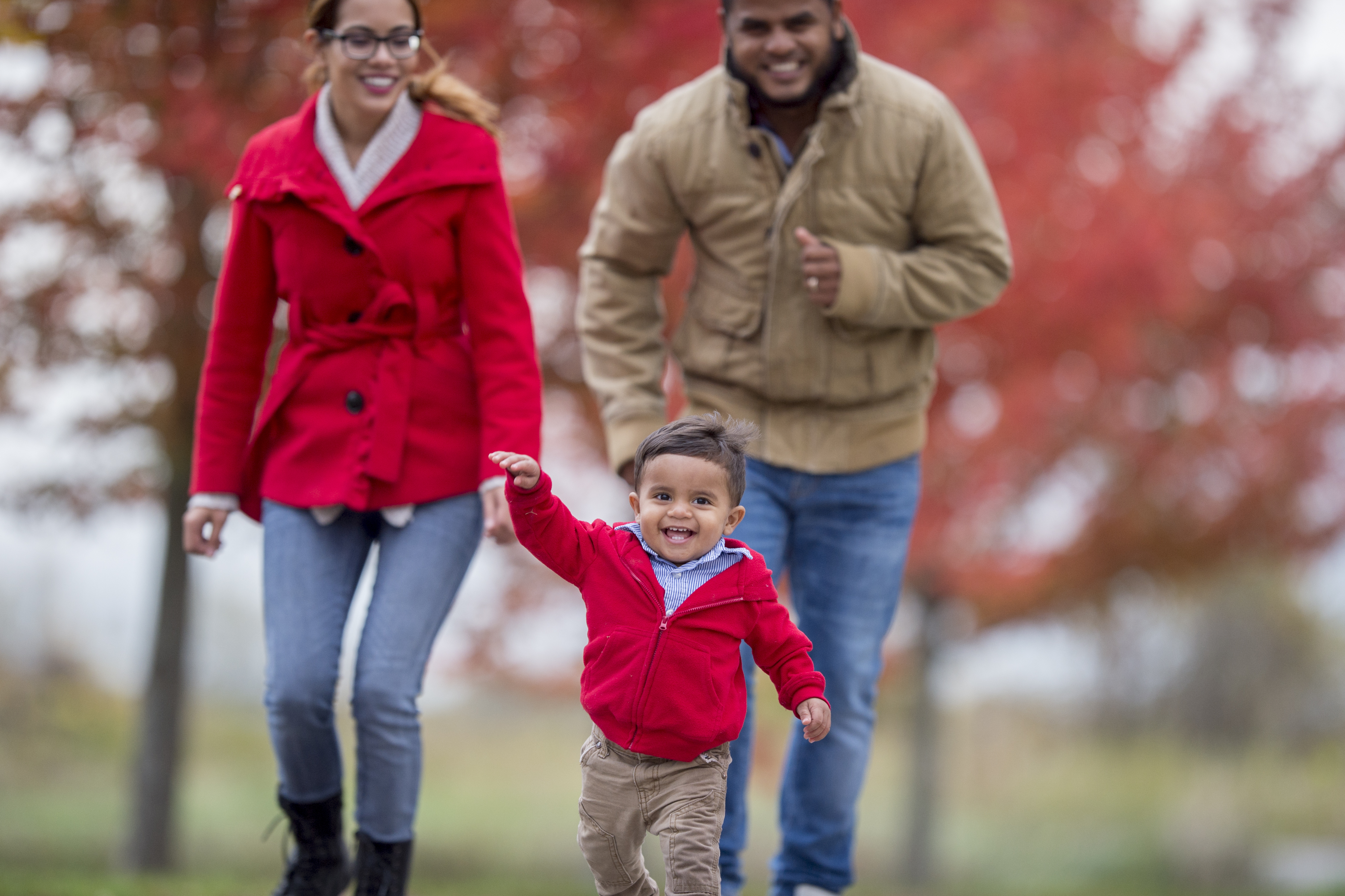 Two adults and a children enjoy a stroll through campus