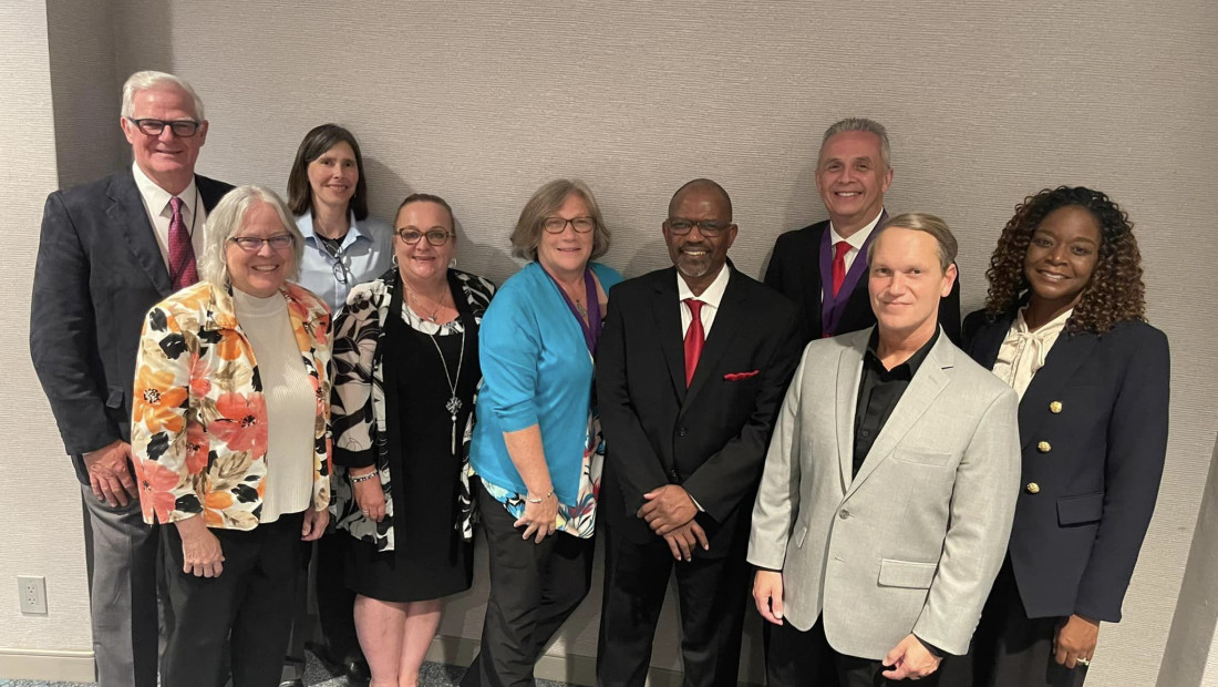 Nine members of the College of Education and Human Ecology gather at an annual conference.