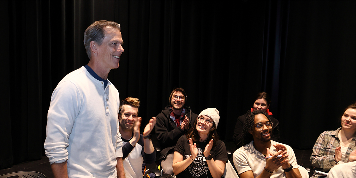 Students applaud Kevin McClatchy's selection as artist laureate.