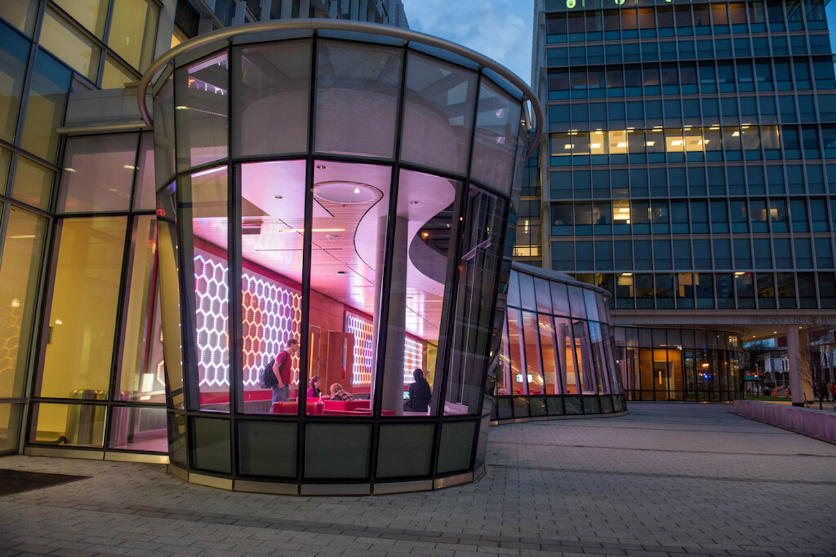 Picture of a colorful building on Ohio State campus, class enclosure with purple and pink lights inside.
