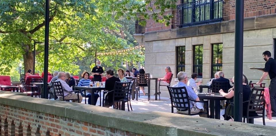 People enjoying lunch on the patio of the Faculty Club