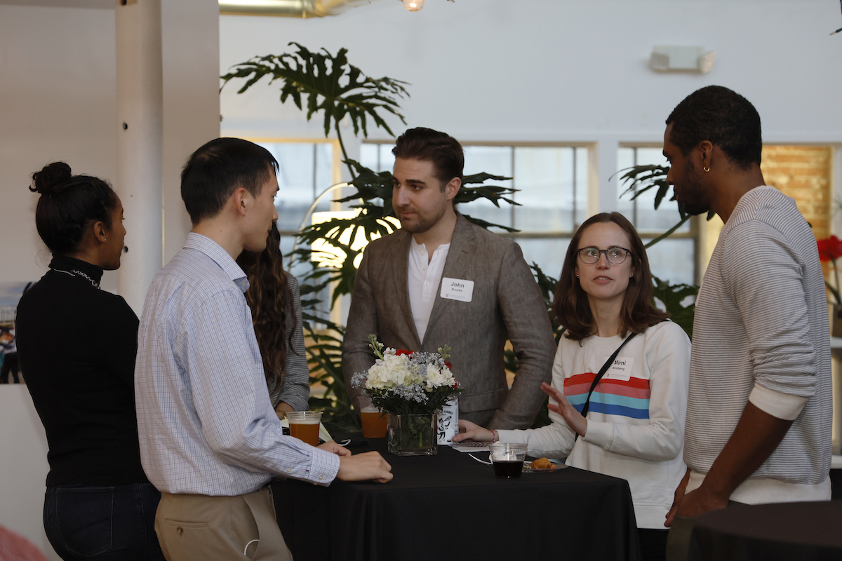 New faculty members talk around a table during a New Faculty Network event.