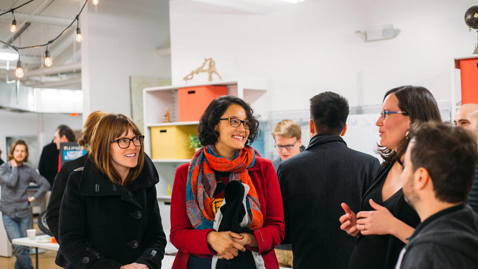 Group of people conversate at The STEAM Factory