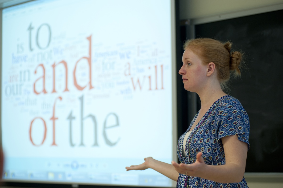 An Ohio State Faculty Member lectures at the front of a classroom.