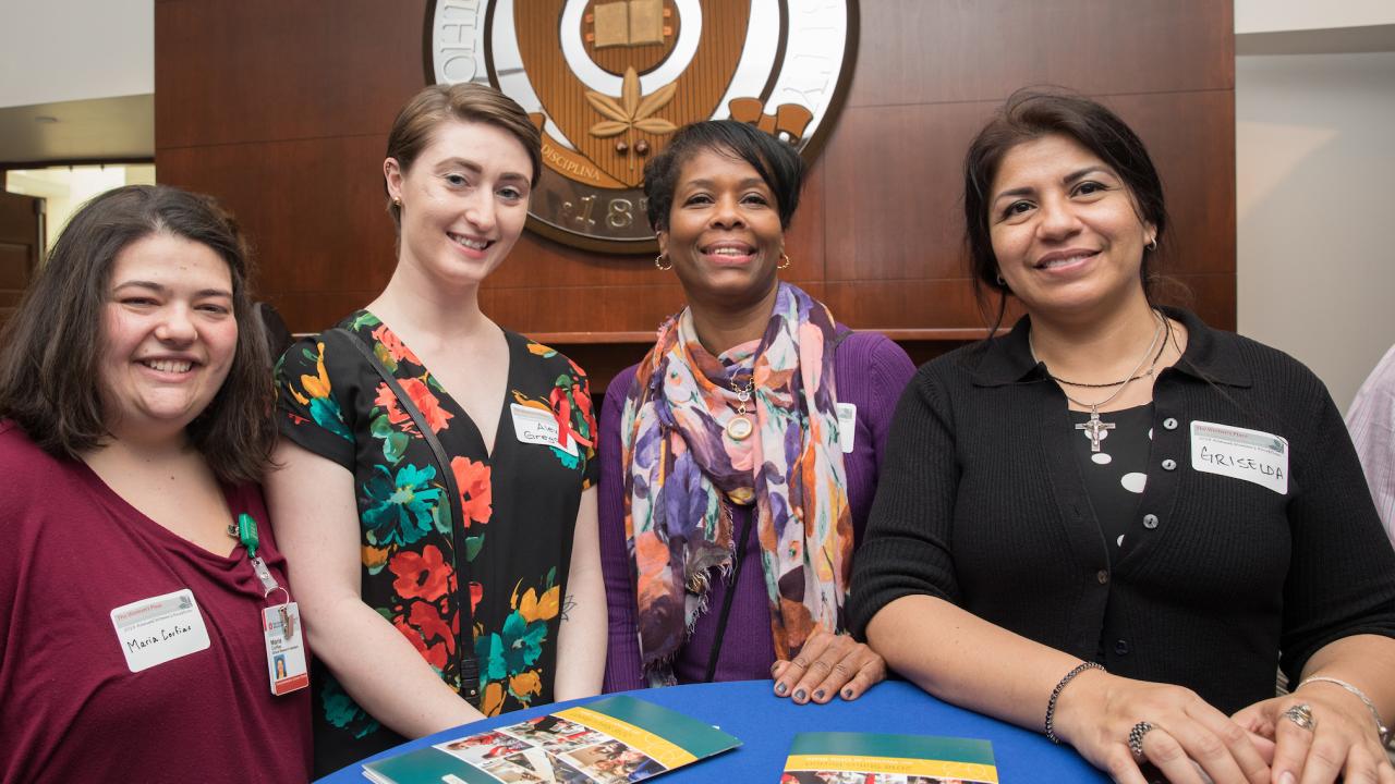 Four members of The Women's Place pose for a photo