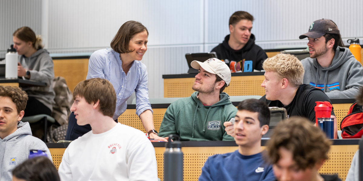 Faculty members interacting with students.