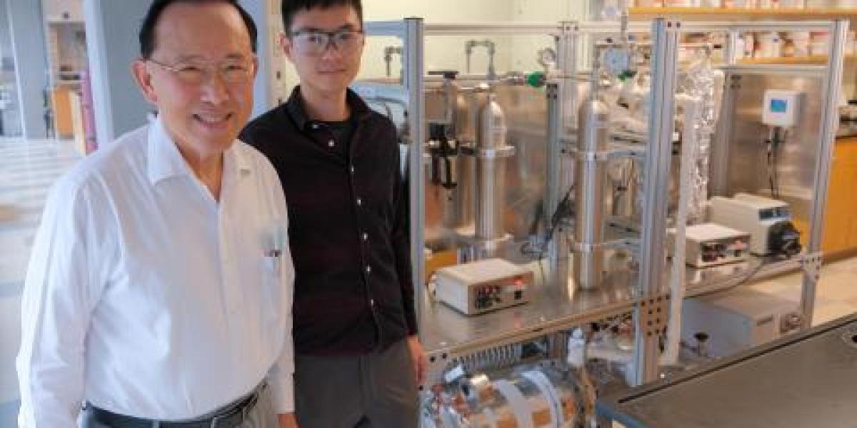 Professor Winston Ho and Research Scientist Yang Han next to their test unit with a 35-square-meter membrane module located at the bottom of the unit, demonstrating their transformational membrane technology’s ability to capture approximately 1 metric ton of carbon dioxide per day.