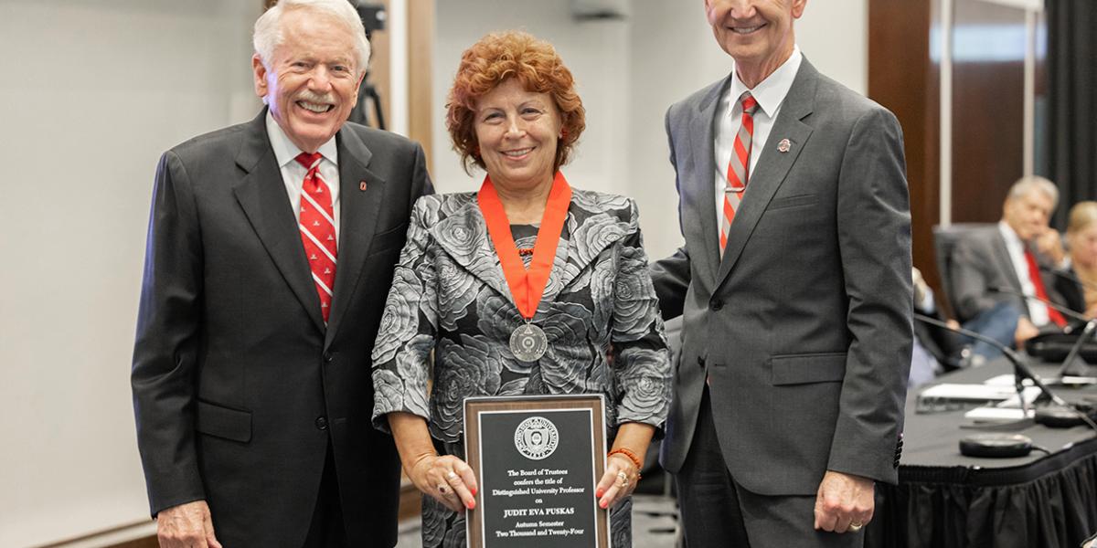 Ohio State Board Chair John Zeiger, Judit Puskas and Ohio State President Ted Carter gather for a photo of Puskas with her award medal and plaque.