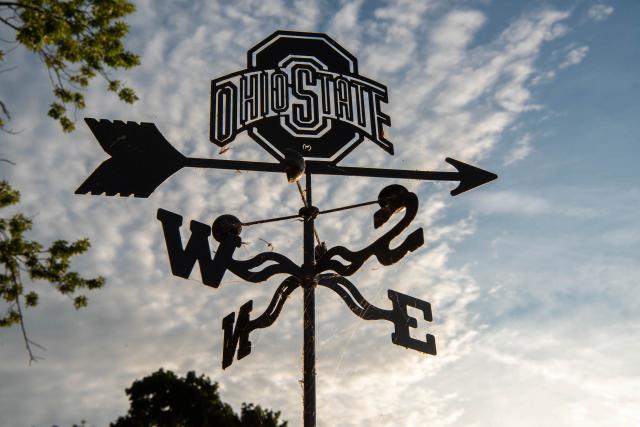 An Ohio State wind dial outdoor with a blue sky background.