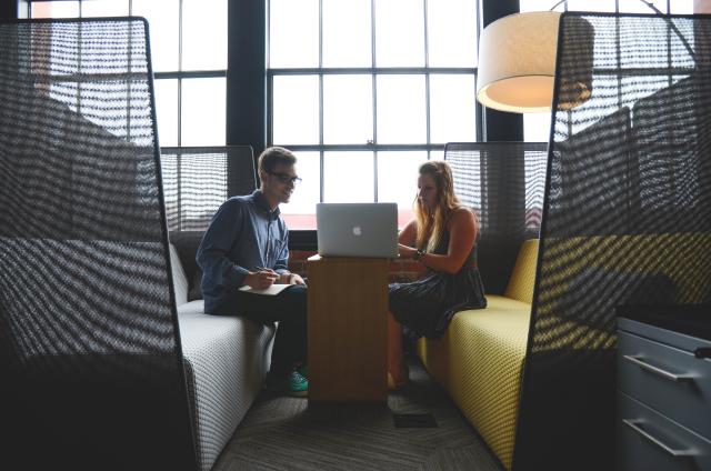 Two people sit in a booth