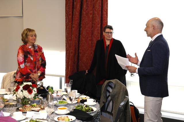 Gail Besner congratulated by two colleages