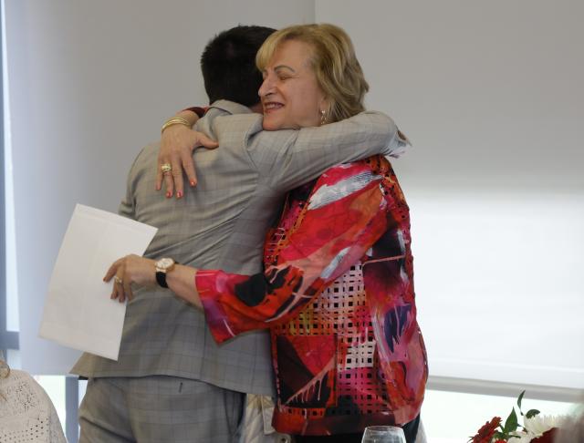 Gail Besner receives a hug from a colleague