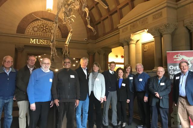 Picture of emeritus academy members standing inside at a museum.