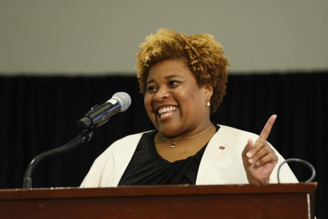 Wendy Smooth speaks at a podium for New faculty Orientation