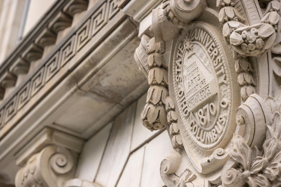 Close up of the university seal on a building
