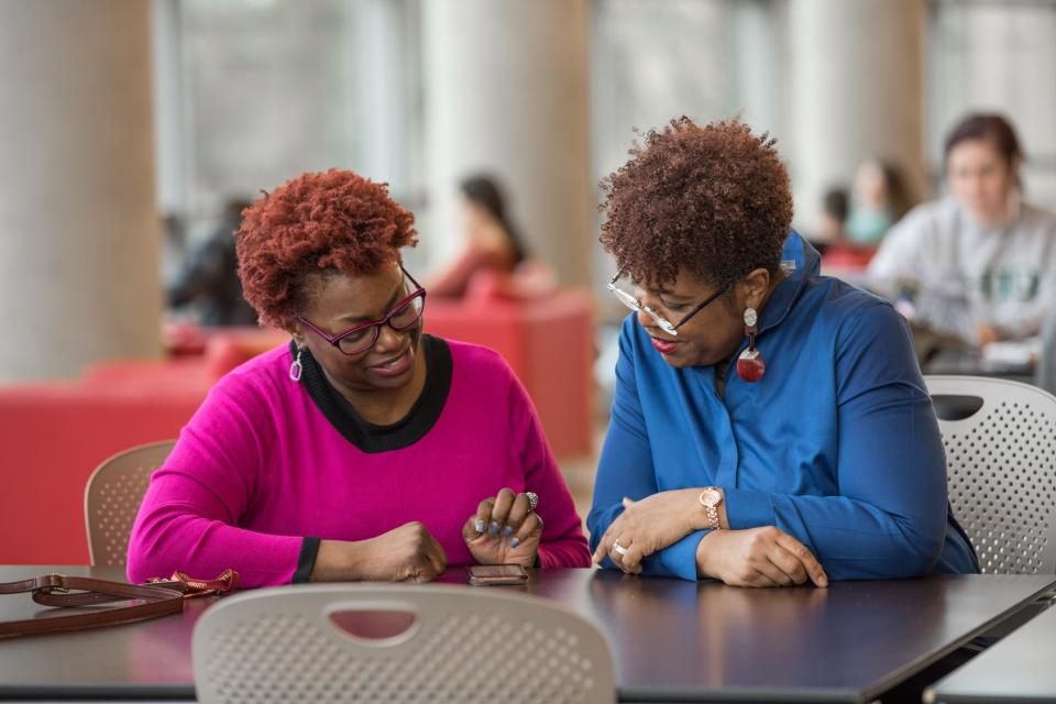 Faculty supporting a student in the reading room of Thompson Library at the Ohio State University