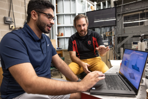 A student and instructor work together in a lab setting.